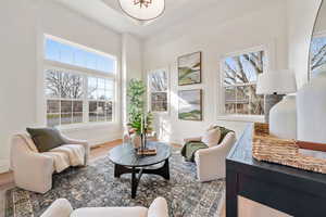 Living area with wood finished floors and plenty of natural light