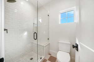 Full bath with a stall shower and toilet