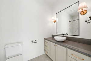 Full bath with vanity and a marble finish shower