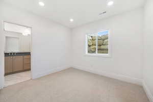 Unfurnished room with light carpet and recessed lighting