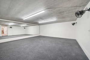 Garage featuring baseboards