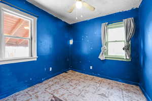Unfurnished room featuring baseboards and ceiling fan