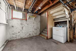 Basement with washer / clothes dryer and stairs