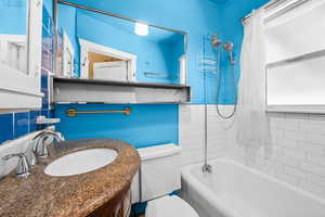 Bathroom featuring tub / shower combination and vanity