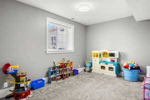 Recreation room with carpet and baseboards