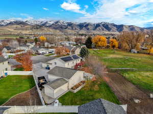 Aerial view of sparsely populated area featuring a mountainous background and nearby suburban area