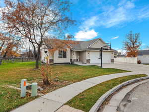 View of front of property with concrete driveway, a garage, and roof with shingles