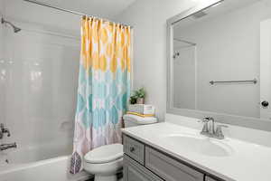 Full bath featuring shower / bathtub combination with curtain and vanity