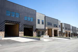 View of front of house with stone siding, a residential view, a garage, and board and batten siding