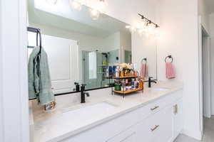 Primary bathroom with a stall shower and double vanity