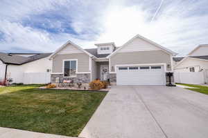 Craftsman house with concrete driveway, stone siding, and an attached garage