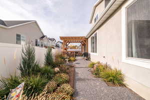 Fenced backyard with a pergola and a patio