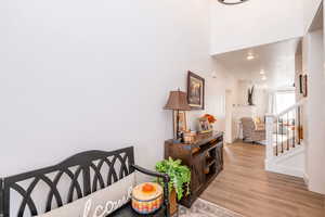 Dining area featuring light wood-style floors, recessed lighting, and stairway