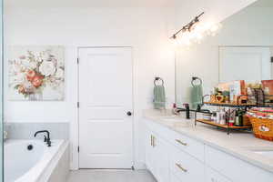 Primary Bathroom featuring double vanity and a bath