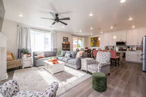 Living area featuring dark wood-style floors, recessed lighting, and a ceiling fan