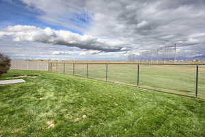 Fenced backyard with a view of Cranefield Golf Course