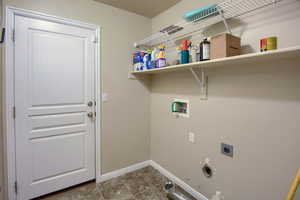 Washroom featuring hookup for a gas dryer, washer hookup, electric dryer hookup, and light tile patterned flooring