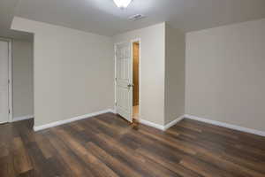 Unfurnished room featuring dark wood finished floors
