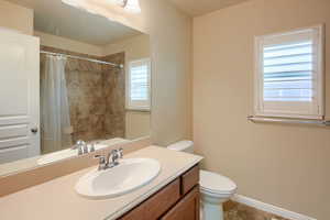 Full bathroom featuring a shower with shower curtain, vanity, and light tile patterned flooring