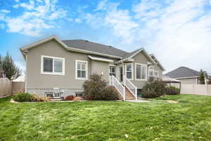 Back of house with stucco siding and a shingled roof