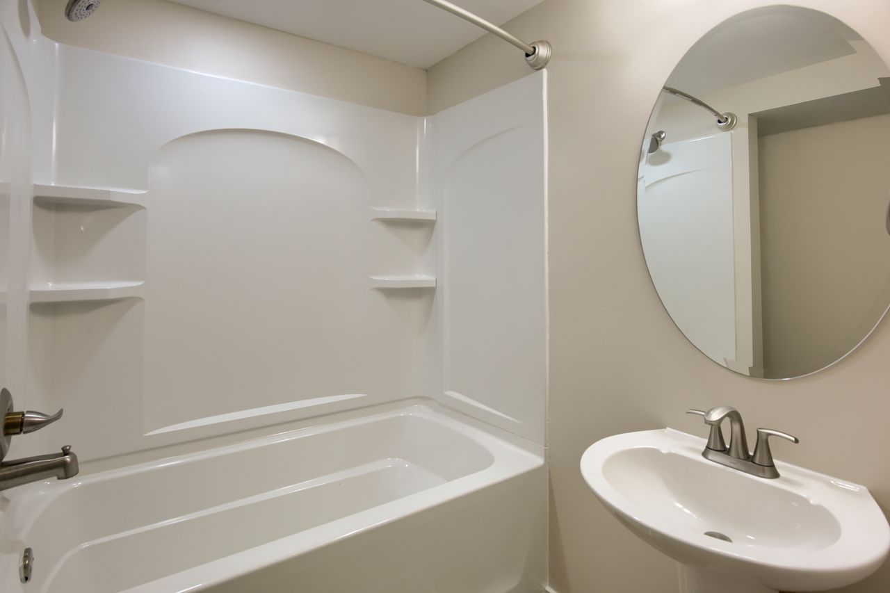 Bathroom with shower / tub combination and a sink
