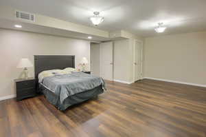 Bedroom featuring dark wood-style flooring and recessed lighting