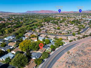Aerial view of property's location featuring a mountainous background and nearby suburban area