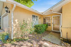 View of exterior entry featuring stucco siding