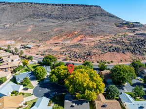 Aerial view of property's location featuring nearby suburban area and a mountainous background