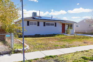 Ranch-style home featuring solar panels