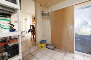 Hall with tile patterned flooring and a wall mounted air conditioner