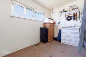 Bedroom with light colored carpet and baseboards