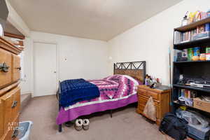 Carpeted bedroom featuring a textured ceiling