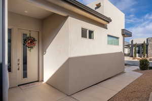 View of exterior entry with stucco siding