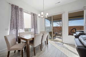 Dining area with a chandelier and light wood finished floors