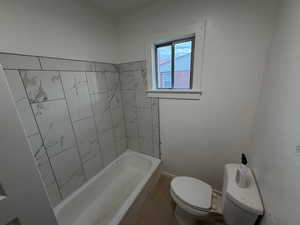 Full bath with toilet and shower / tub combination