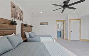 Carpeted bedroom featuring recessed lighting, a ceiling fan, and connected bathroom