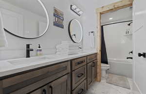 Full bath with shower / bath combo with shower curtain, double vanity, light marble finish floors, and recessed lighting