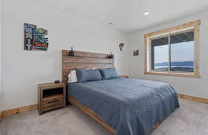 Carpeted bedroom with baseboards and recessed lighting