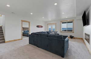 Living room with light carpet, recessed lighting, stairway, and french doors