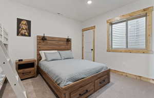 Carpeted bedroom with recessed lighting and baseboards