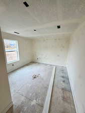 Spare room featuring a textured ceiling