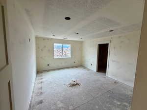 Unfurnished room with a textured ceiling