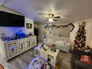 Living area with wood finished floors and ceiling fan