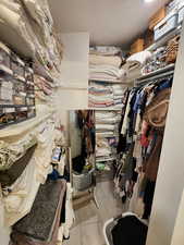 Spacious closet with light tile patterned flooring