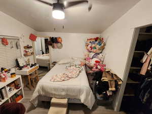 Bedroom with ceiling fan and light wood finished floors