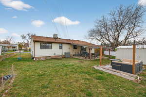 Rear view of property featuring a covered patio, a fenced backyard, and a shed