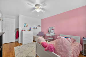 Bedroom with light hardwood flooring and ceiling fan