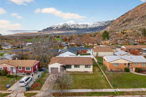 Aerial perspective of neighborhood with a mountain backdrop