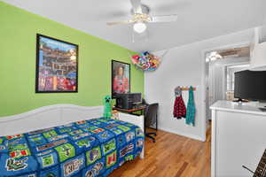 Bedroom with light hardwood flooring and ceiling fan